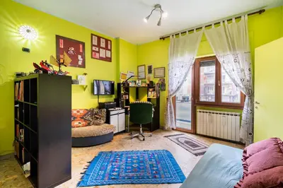 a living room with yellow walls and a desk at Fine Art House in Rome