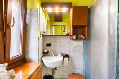 a bathroom with a sink and a mirror at Fine Art House in Rome