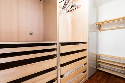 a walk in closet with wooden dividers in a room at Design Apartment close to Trastevere in Rome