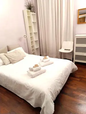 a bedroom with a white bed with towels on it at Design Apartment close to Trastevere in Rome