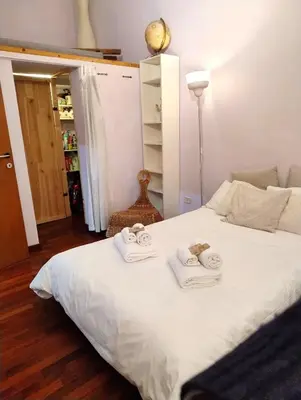 a bedroom with a white bed with towels on it at Design Apartment close to Trastevere in Rome