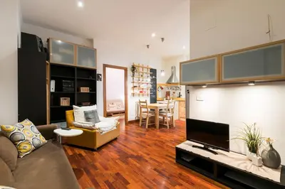 a living room with a couch and a table at Design Apartment close to Trastevere in Rome