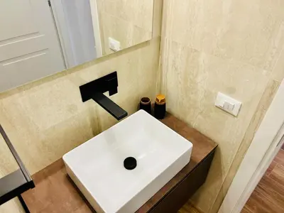a white sink in a bathroom with a mirror at LP San Giovanni Apartment in Rome
