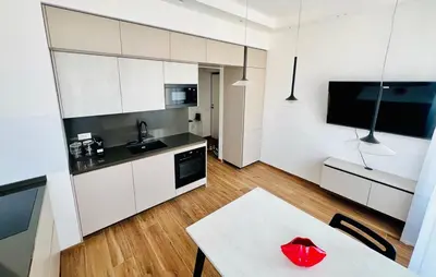 a kitchen with white cabinets and a table with a red heart on it at LP San Giovanni Apartment in Rome