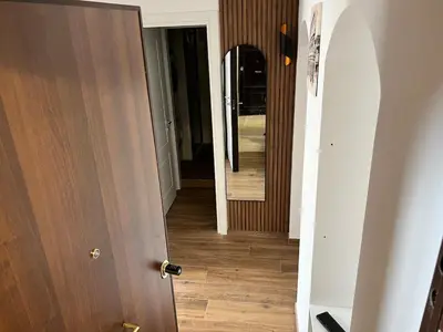 an open door leading to a hallway with a mirror at LP San Giovanni Apartment in Rome
