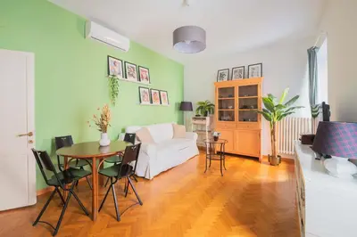 a living room with a table and a white couch at Maison Rinascimento Roma in Rome