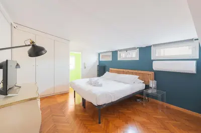 a bedroom with a bed and a blue wall at Maison Rinascimento Roma in Rome