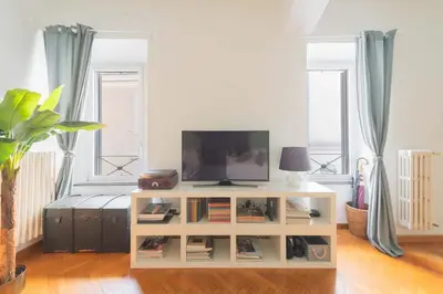 a living room with a tv on a white cabinet at Maison Rinascimento Roma in Rome