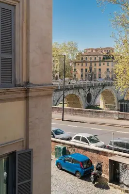 a blue car parked on the side of a street at Maison Rinascimento Roma in Rome