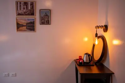 a lamp on a table with a tea kettle on it at Sanlorenzo MaDa House in Rome