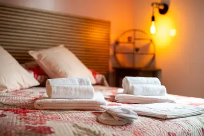 a bed with towels on top of it at Sanlorenzo MaDa House in Rome
