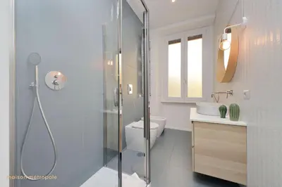 a bathroom with a shower and a toilet and a sink at Casa Magnifica in Rome