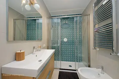 a bathroom with a sink and a glass shower at Casa Magnifica in Rome