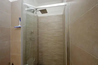 a shower with a glass door in a bathroom at Trevi Suite Apartment - Barberini in Rome