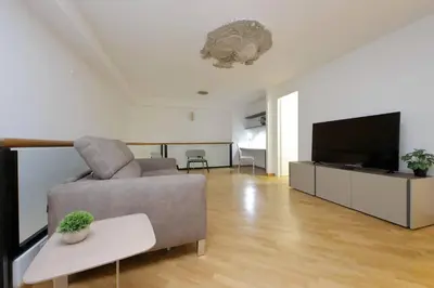 a living room with a couch and a flat screen tv at Trevi Suite Apartment - Barberini in Rome