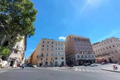 an empty street in a city with buildings at Trevi Suite Apartment - Barberini in Rome