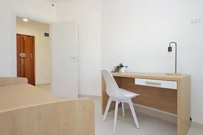a white chair sitting at a desk in a room at Attico di Design a Garbatella con Vista San Pietro in Rome