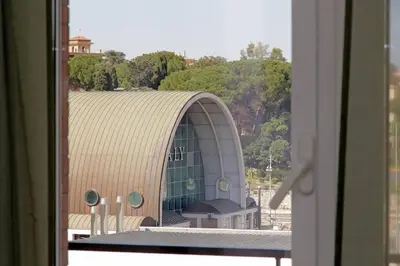a view of a building from a window at Attico di Design a Garbatella con Vista San Pietro in Rome