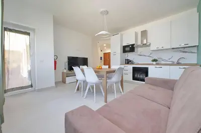 a living room with a couch and a table and chairs at Attico di Design a Garbatella con Vista San Pietro in Rome