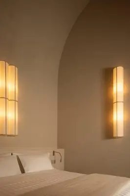 a bedroom with two lights on the wall at Velvet Grey Boutique Hotel Roma in Rome