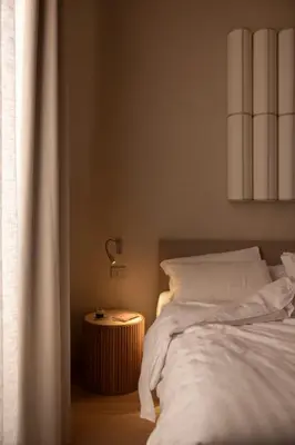 a bedroom with a bed and a table with a lamp at Velvet Grey Boutique Hotel Roma in Rome