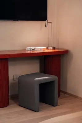 a desk with a box on top of it with a stool at Velvet Grey Boutique Hotel Roma in Rome