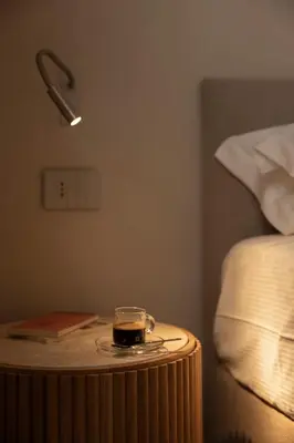 a table with a candle on it next to a bed at Velvet Grey Boutique Hotel Roma in Rome