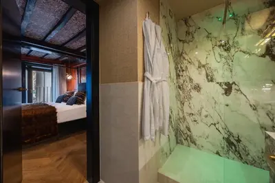 a bathroom with a shower and a bed in a room at Pantheon Suite - Residenze di Charme in Rome