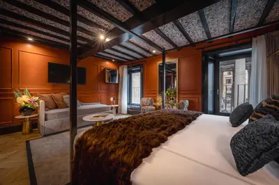a bedroom with orange walls and a large bed at Pantheon Suite - Residenze di Charme in Rome