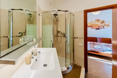 a bathroom with a sink and a shower at MICLAD Colosseum Guest House in Rome