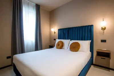 a bedroom with a large bed with two hats on it at Bocca di Leone Luxury Suite in Rome