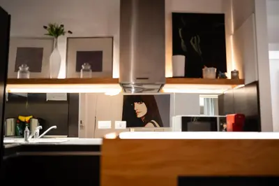 a kitchen with a sink and a picture of a woman at Silver Spanish's steps in Rome