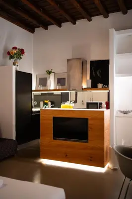 a kitchen with a large wooden counter in a room at Silver Spanish's steps in Rome
