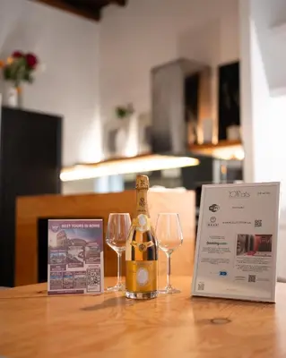 a bottle of champagne and two wine glasses on a table at Silver Spanish's steps in Rome