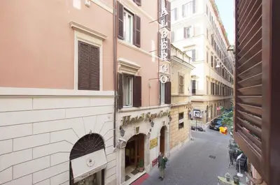a person walking down a street next to a building at Silver Spanish's steps in Rome