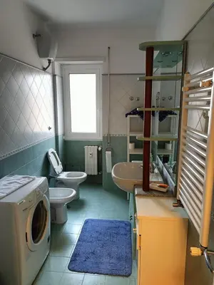 a bathroom with a washing machine and a washer at Casa Caselli in Rome
