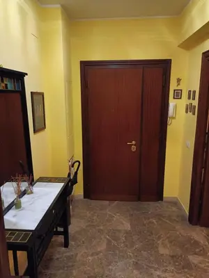 a room with a wooden door and a table and a table sidx sidx at Casa Caselli in Rome