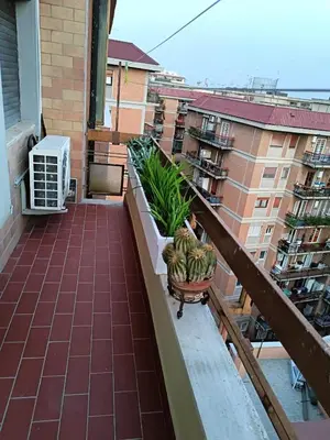 a balcony with potted plants on a building at Casa Caselli in Rome