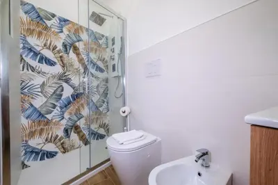 a bathroom with a toilet and a shower and a sink at Pantheon Charming by Varental in Rome