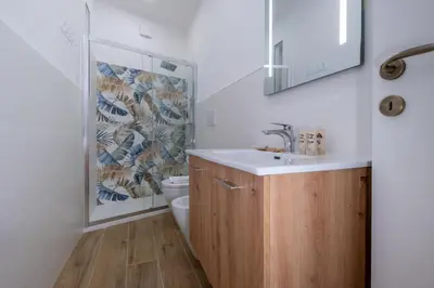a bathroom with a sink and a toilet and a mirror at Pantheon Charming by Varental in Rome