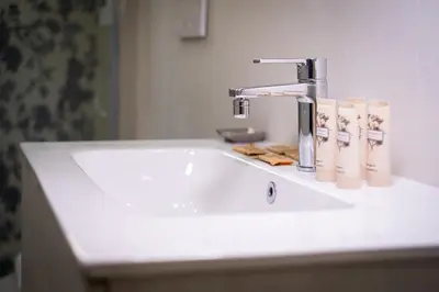 a bathroom sink with a faucet and towels on it at Pantheon Charming by Varental in Rome