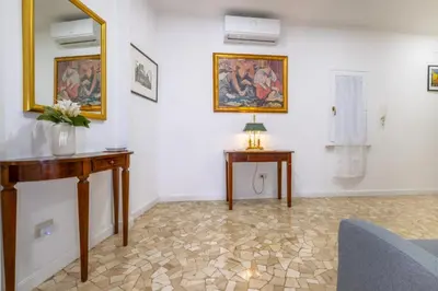 a living room with two tables and a mirror at Pantheon Charming by Varental in Rome