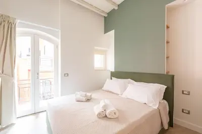 a bedroom with a bed with towels on it at Residenza Foraggi 83 in Rome