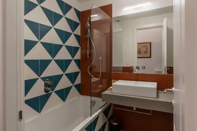 a bathroom with a sink and a mirror at GuestHost - Rione Prati Apartments in Rome