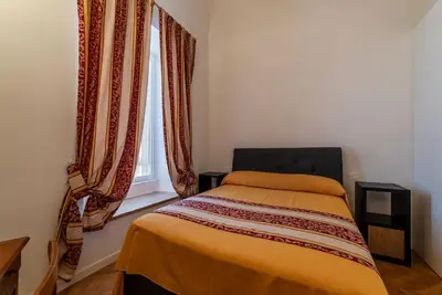 a bedroom with a bed and a window with curtains at GuestHost - Rione Prati Apartments in Rome
