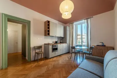 a kitchen and living room with a couch and a table at GuestHost - Rione Prati Apartments in Rome