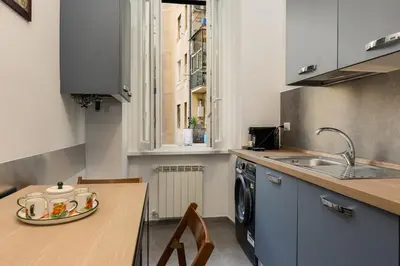 a kitchen with a sink and a table with a plate on it at Giuliana Apartment Vatican in Rome