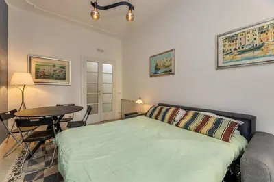 a bedroom with a bed and a table in it at Giuliana Apartment Vatican in Rome