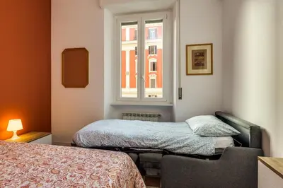 a small bedroom with a bed and a window at Giuliana Apartment Vatican in Rome