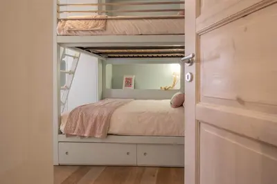 a bedroom with a bunk bed and a door at Suite Color Family Roma in Rome